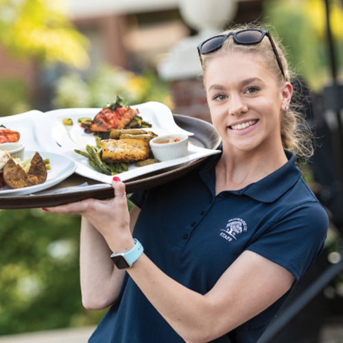 staff serving food on the outdoor terrace at Brookside Country Club