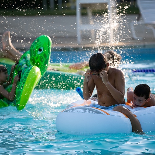 kids on tubes in pool at Brookside Country Club